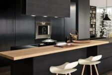 08 a contemporary black kitchen with sleek cabinets, built-in appliances, a light-colored wood countertop and a black hood