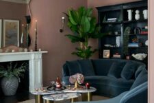 11 a beautiful living room with mauve walls, a fireplace, a navu curved sofa, a black storage unit and a potted plant