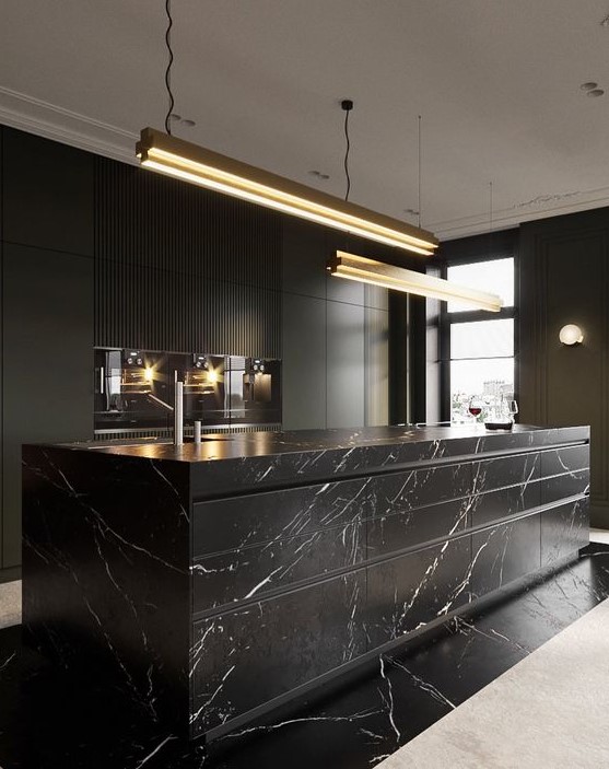 A luxurious black kitchen with sleek cabinets, built in appliances, a large marble kitchen island and pendant lamps