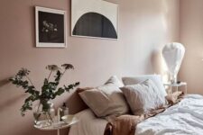 14 a dreamy bedroom with blush walls, muted color bedding, greenery and a monochromatic gallery wall