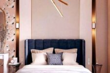 15 a modern luxurious bedroom with pink walls, catchy wallpaper, a navy bed, neutral bedding and touches of gold here and there