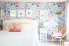 19 an airy bedroom with a bright floral accent wall, a white bed with neutral bedding, a blue boho rug, a rattan chair and white nightstands