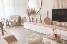 21 a warm neutral boho living room with a sofa and a wovne pouf, a tiered coffee table, a wood slat wall and a TV unit
