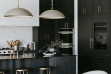 22 a sophisticated black and white kitchen with black and white cabinets, a black fluted kitchen island and gorgeous metal lamps hanging on chain