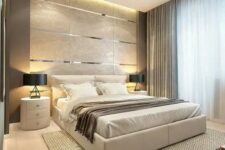 24 a gorgeous contemporary bedroom with a tile and metallic line accent wall, a neutral upholstered bed, round white nightstands, black lamps and several layers of light