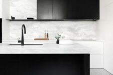 26 a stylish black and white kitchen with sleek white and black cabinets, a large kitchen island, black fixtures and greenery