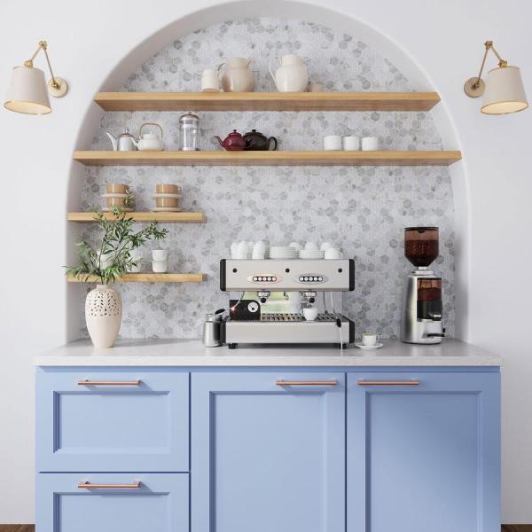 a home coffee bar with an arched niche with shelves showing off some mugs and teapots, a coffee machine and some greenery