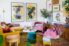 34 a bold maximalist living room with a mustard sectional, pink chairs, an emerald pouf, a bold gallery wall and a bright rug plus statement plants