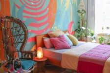 35 a bright boho sleeping space with a wall mural, a bed with colorful bedding and a rug, a woven pendant lamp and a papasan chair