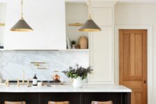 35 a chic white kitchen with shaker cabinets, open shelves, a large hood, a black kitchen island with a white stone countertop
