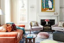 36 a maximalist living room with a coral sofa, a bold blue rug, pastel ottomans, lilac chairs and a bold artwork