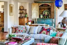 37 an ethnic maximalist living room with pastel blue seating furniture, a turquoise buffet, a Moroccan lamp and bold ethnic textiles