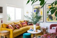41 a maximalist living room with a yellow sofa, pink chairs, various tables and bold artworks plus potted plants