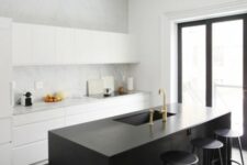 41 a minimalist white kitchen with sleek cabinets, a black kitchen island, black stools and gold touches