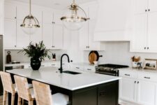 43 a modern white farmhouse kitchen with shaker cabinets, a black kitchen island, white woven stools and sphere pendant lamps
