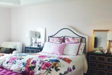 46 a glam bedroom with an upholstered bed and floral bedding, a fuchsia upholstered bench, black dressers and a chair
