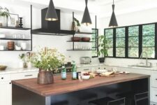 49 a white farmhouse kitchen accented with a black mosaic floor, a black kitchen island and black pendant lamps