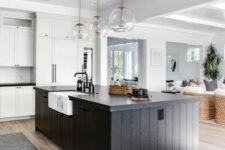50 a white kitchen with shaker cabinets, a black slatted kitchen island, glass sphere pendant lamps