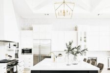 51 a white modern farmhouse kitchen with shaker cabinets, a black kitchen island, gold touches and greenery