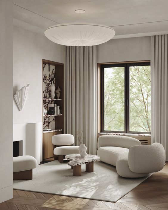 Neutral living room with sculptural furniture, a built in storage niche and neutral textiles