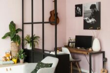52 a Scandinavian living room in pink with a home office nook with a desk, a storage unit, a chair and some artwork