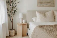 58 a soothing Japandi bedroom with an upholstered bed with neutral bedding, a wooden nightstand, a potted plant