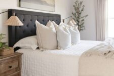 64 a soothing neutral bedroom with a charcoal grey upholstered bed, neutral bedding, a stained wooden nightstand