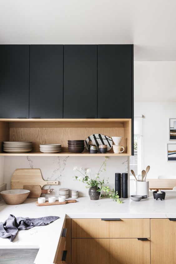 A black and light stained kitchen with white quartz countertops and a backsplash is a lovely and chic contemporary space