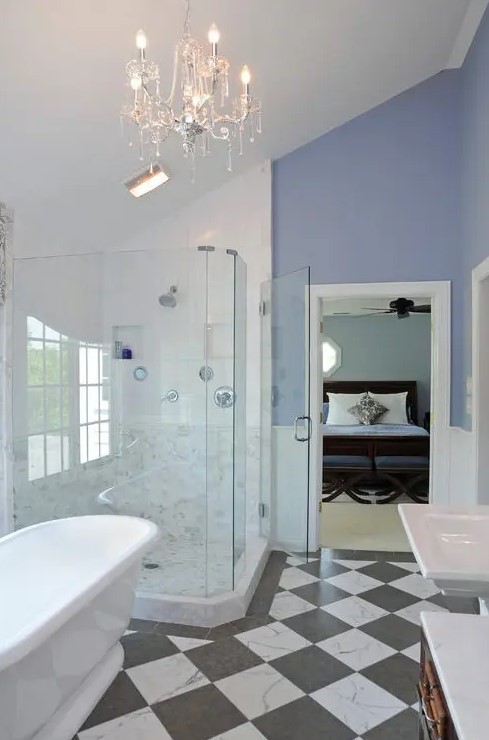 a chic and refined bathroom with periwinkle walls, white wainscoting, a checked floor, a shower, an oval tub and white appliances
