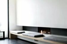 a minimalist ethanol fireplace, a comfy bench next to it bring a touch of luxury to the interior