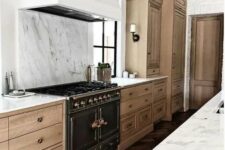 02 a beautiful and refined kitchen with light-stained cabinetry, a white hood and a white marble backsplash plus countertops