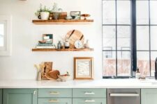 04 a beautiful sage green kitchen with white stone countertops, open shelves, rich stained touches and gold handles is very chic