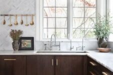 12 a jaw-dropping walnut kitchen with white stone countertops and white marble tiles plus touches of gold
