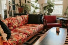 20 a mid-century modern lviing room with a black and white rug, a floral sofa, rust-colored chairs, potted plants and a floor lamp