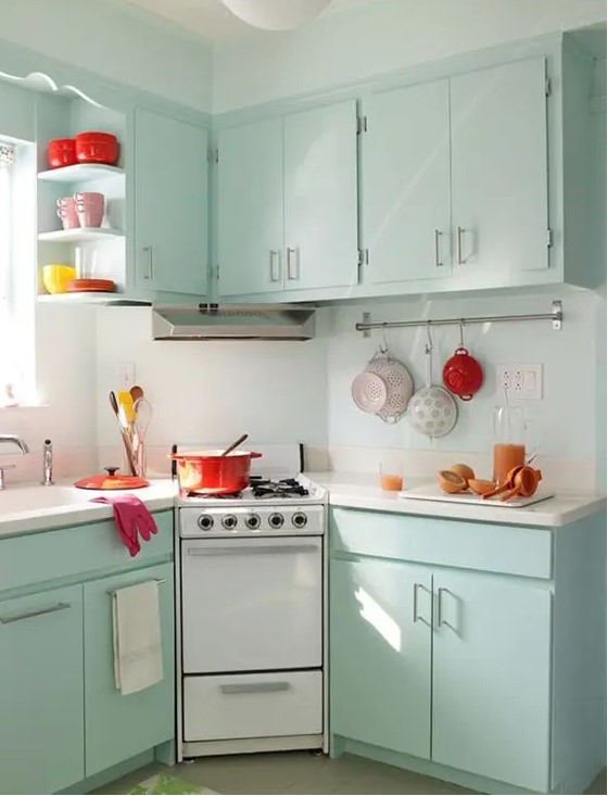 Mint colored cabinets and some bold tableware are all you need to create a retro feel in the kitchen