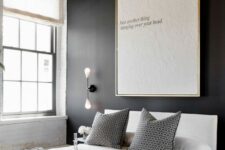 a b&w bedroom with a bold black wall