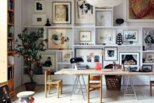 29 a double-height space with a large gallery wall taking the whole wall, a bookcase, a living edge desk, several chairs and a bright rug