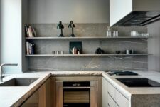 33 a minimalist grey kitchen with stone countertops and a backsplash plus open shelves instead of upper cabinets and built-in appliances