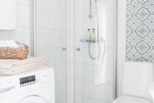 34 a small and lovely neutral bathroom with printed and white squre tiles, a white toilet and a washing machine is airy and cool