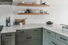 42 a stylish sage green kitchen with shaker style cabinets, white countertops and a white skinny tile backsplash plus floating shelves