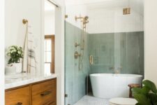 44 a mid-century modern bathroom with sage green tiles in the bathing zone, a printed tile floor, a stained vanity and a basket