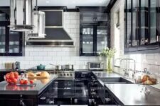 a bold art deco black and white kitchen with black cabinets with glass fronts, a striped floor, glossy black cabinets and concrete countertops