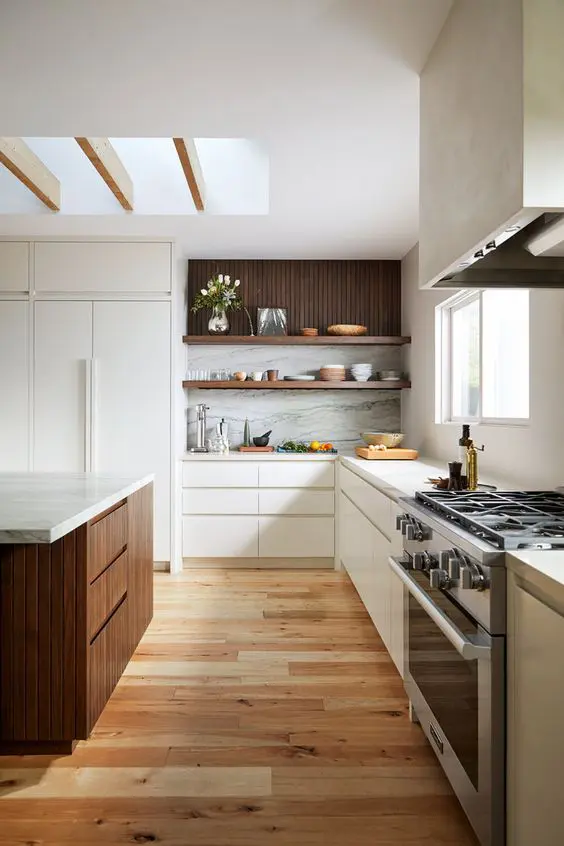 A contemporary kitchen sleek flat panel white cabinets, open shelves, a dark stained kitchen island and white stone countertops