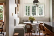 a cozy dining room with shiplap walls