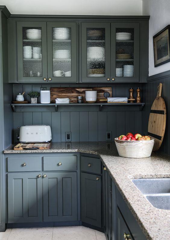 a graphite grey kitchen with inlay and glass cabinets, open shelves, grey granite countertops, a beadboard backsplash