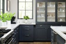 a graphite grey traditional kitchen with stainless teel accents and appliances and vintage lamps