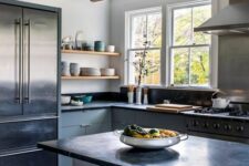 a light grey kitchen with flat panel cabinets and a kitchen island, black soapstone countertops, wooden beams and open shelves
