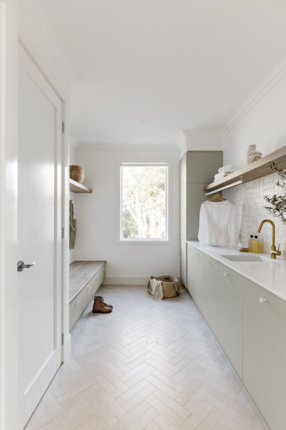 a neutral mudroom laundry with flat panel cabinets, a built-in bench with storage, open shelves, a herringbone floor