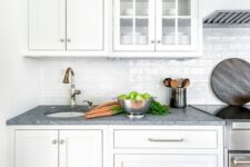 a pure white kitchen with shaker and glass cabinets, a white subway tile backsplash and grey granite countertops is lovely