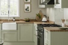 a sage green kitchen with grey walls, butcherblock countertops, a black cooker and a hood, a vintage sink and fixtures